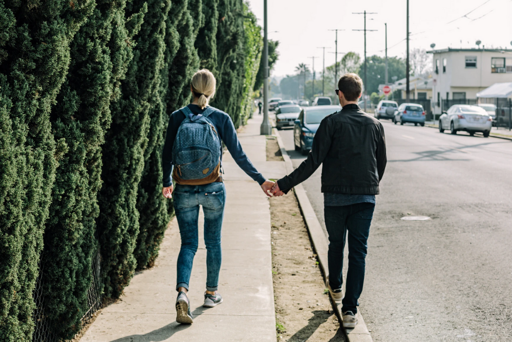 young couple walks outside in their neighbourhood