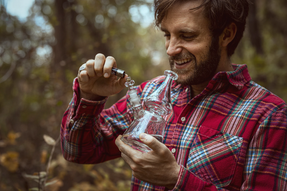 man in red plaid shirt dabs outside