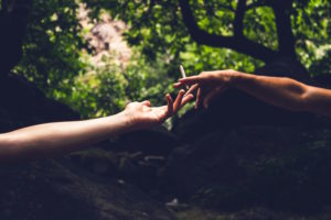 Person passing a joint to another person